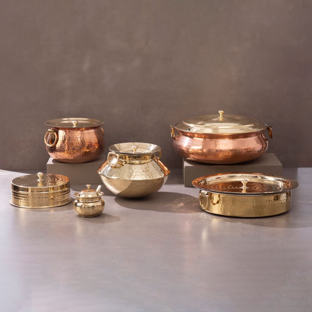Copper and brass cookware collection with pots casseroles and serving vessels