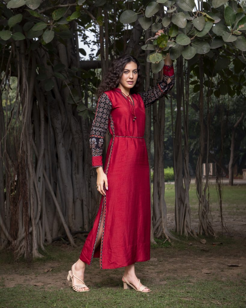 Red embroidered dress near banyan tree fashion shoot by sandeep vishwakarma